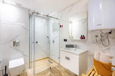 a bathroom with a shower and a toilet and a sink at Large elegant 2BR Apt in Gueliz in Marrakech