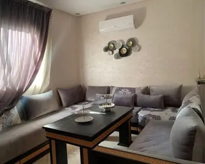 a living room with a couch and a table at well-equipped apartment in Marrakech