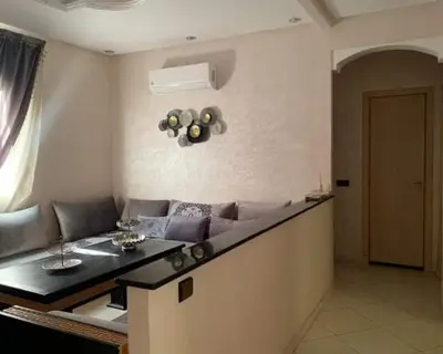a living room with a couch and a table at well-equipped apartment in Marrakech