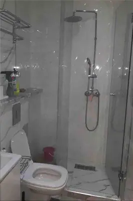 a bathroom with a shower and a toilet and a sink at well-equipped apartment in Marrakech