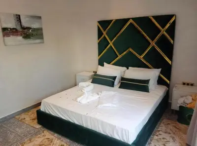 a bedroom with a bed with a large headboard at Villa akiba in Marrakech