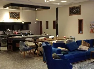 a living room with a blue couch and a table at Villa akiba in Marrakech