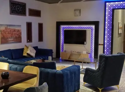 a living room with a blue couch and a large mirror at Villa akiba in Marrakech