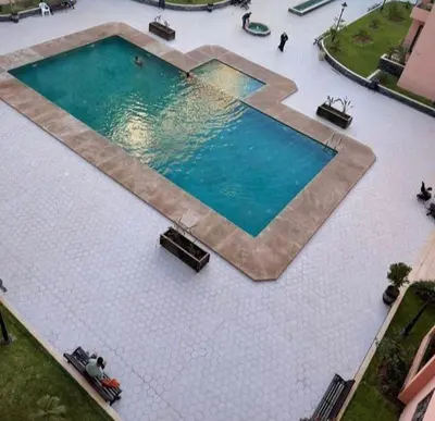 an overhead view of a large swimming pool at Bel appartement au cœur de Marrakech in Marrakech