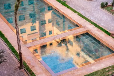 an overhead view of a swimming pool with a palm tree at Central Gueliz 2 min M Avenue Balcony Pool View in Marrakech