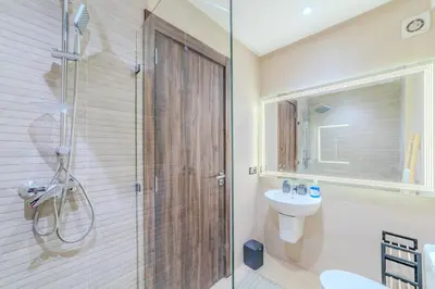 a bathroom with a shower and a toilet and a sink at Central Gueliz 2 min M Avenue Balcony Pool View in Marrakech