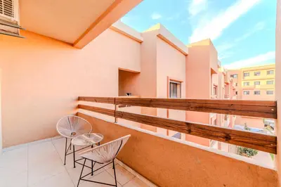a balcony with two chairs and a view at Central Gueliz 2 min M Avenue Balcony Pool View in Marrakech