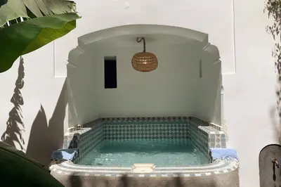 a small pool of water in a building with at mon riad in Marrakech