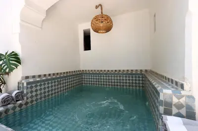 a swimming pool in a room with a large pool at mon riad in Marrakech