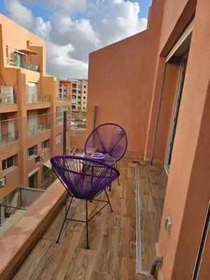 a purple chair sitting on top of a balcony at Apparemment haut de gamme à l'hivernage in Marrakech