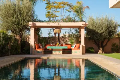 a gazebo with a pool in a yard at La Salea - Golf Amelkis in Marrakech