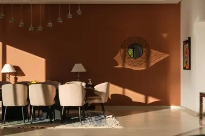 a dining room with chairs and a table and a mirror at La Salea - Golf Amelkis in Marrakech