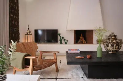a living room with a table and chairs and a tv at Villa Ty Habibi - Super 5 Bedroom with Private Heated Pool by the Golf Amelkis in Marrakech