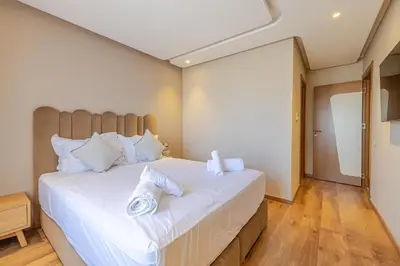 a bedroom with a large bed with white pillows at Luxueux appartement à Riad Garden in Marrakech