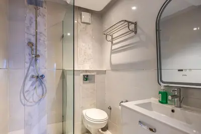 a bathroom with a shower and a toilet and a sink at Luxueux appartement à Riad Garden in Marrakech