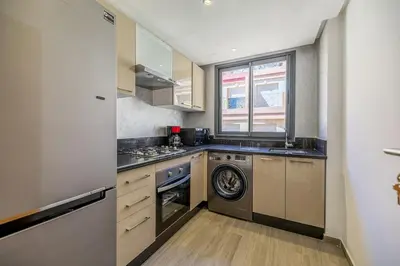 a kitchen with a washer and dryer in it at Cozy & Elegant appart in hypercenter of Marrakech in Marrakech