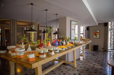a long table filled with vases and bowls of food at Radisson Blu Marrakech, Carré Eden in Marrakech