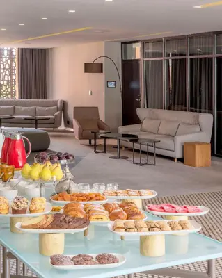 a buffet of pastries on a table in a living room at Radisson Blu Marrakech, Carré Eden in Marrakech