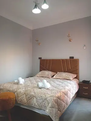 a bedroom with a bed with two stuffed animals on it at Airport Menara Appartment in Marrakech