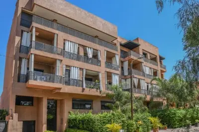 a large building with balconies on the side of it at Chic & Modern in City Center - Pool, IPTV & Comfort in Marrakech
