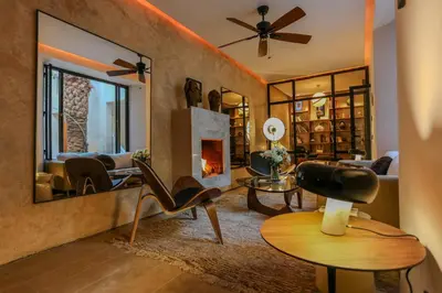 a living room with a fireplace and a couch at Riad KO Nova in Marrakech