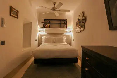 a bedroom with a bed with a ceiling fan at Riad KO Nova in Marrakech