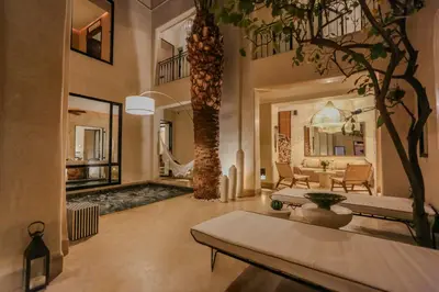 a living room with a table and a tree at Riad KO Nova in Marrakech