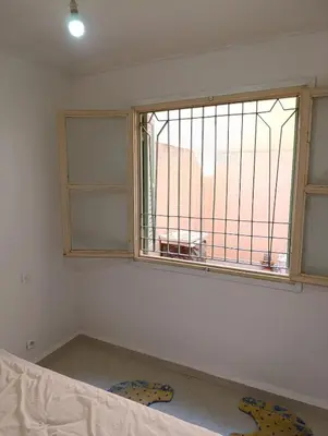 a room with a window and a bed in front of it at Marrakech welcome in Marrakech