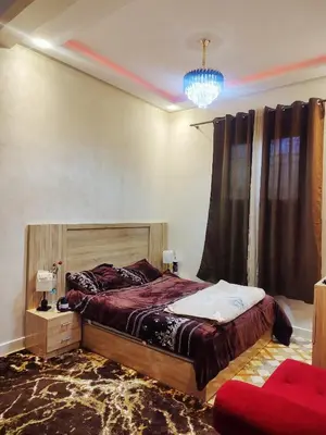 a bedroom with a bed and a chandelier at Relaxing Family Home outside Marrakech in Marrakech