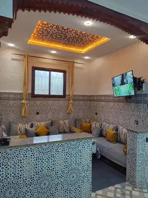 a living room with a couch and a tv at Relaxing Family Home outside Marrakech in Marrakech