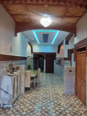 a dining room with a table and a blue light at Relaxing Family Home outside Marrakech in Marrakech