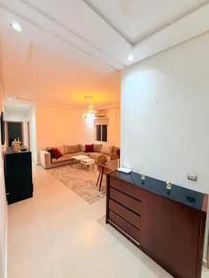 a living room with a large projection screen on the wall at Appartement Tachfine lumineux FAMILY in Marrakech