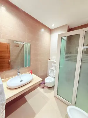 a bathroom with a sink and a toilet at Appartement Tachfine lumineux FAMILY in Marrakech