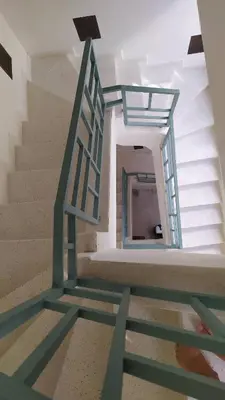 a stairway with a green metal stair railing at Riad rooftop, pool and stunning view in Marrakech