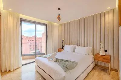 a bedroom with a large bed and a large window at Elegant 2BR apartment in Gueliz in Marrakech