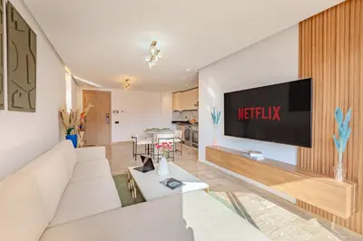 a living room with a television on a wall at Elegant 2BR apartment in Gueliz in Marrakech