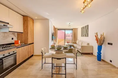 a kitchen and living room with a table and chairs at Elegant 2BR apartment in Gueliz in Marrakech