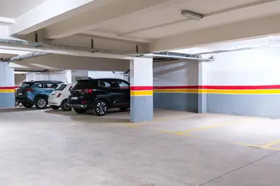 a parking garage with cars parked in it at New! Apartment Gueliz 2 min M Avenue with Pool and 24h Security & Parking in Marrakech