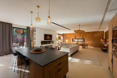a kitchen and living room with a table and a couch at Villa luxe Dar Paumar, Marrakech in Marrakech