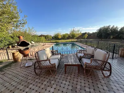 a patio with chairs and a swimming pool at Magnifique Riad, Élégance et Charme Authentique à Marrakech in Marrakech