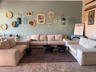 a living room with a couch and chairs and mirrors at Magnifique Riad, Élégance et Charme Authentique à Marrakech in Marrakech