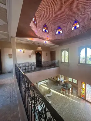 an empty room with a balcony with stained glass windows at Magnifique Riad, Élégance et Charme Authentique à Marrakech in Marrakech