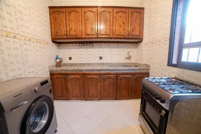 a kitchen with a washing machine and a washer at Family Apartment in Marrakech 3 Bedrooms & Balcony with View in Marrakech