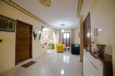 a living room with a kitchen and a hallway with a door at Family Apartment in Marrakech 3 Bedrooms & Balcony with View in Marrakech