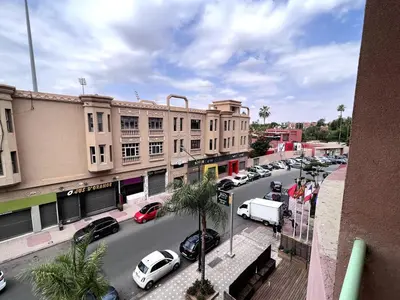 a city street with cars parked in front of buildings at Superb Location in Marrakech in Marrakech