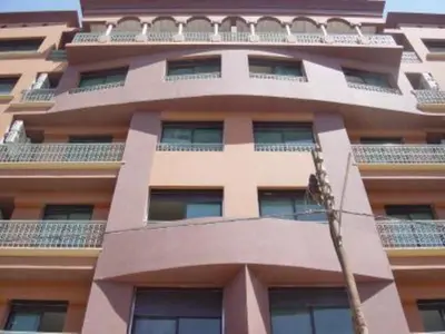 a tall building with balconies on top of it at Superb Location in Marrakech in Marrakech