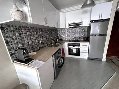 a kitchen with a refrigerator and a washer and dryer at Superb Location in Marrakech in Marrakech