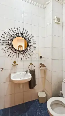 a bathroom with a mirror and a sink and a toilet at Appartement charmant à Guéliz in Marrakech