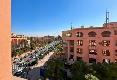 a city street with cars parked in a parking lot at Appartement charmant à Guéliz in Marrakech