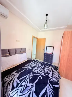 a bedroom with a bed in a room at Appart N35 COSY CONFORT FAMILY in Marrakech